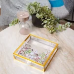 Jewellery keepsake boxes in assorted sizes with floral artwork inside transparent lids.