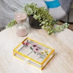 Elegant gold-edged storage boxes with botanical prints, perfect for gifts or decor.