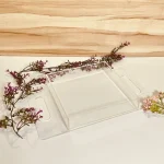 Transparent acrylic tray with glossy finish and flat handles