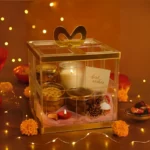 Acrylic bow basket filled with chocolates, cookies, and gifts.