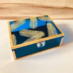 Angled view of neon blue Feather Print Box with gold detailing.