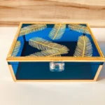 Feather Print Box used as a jewelry organizer on a dresser.