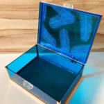 Feather Print Box slightly open, showing acrylic neon blue sides and secure clasp.
