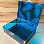 Feather Print Box slightly open, showing acrylic neon blue sides and secure clasp.