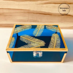 Neon blue Feather Print Box with golden feather motifs and gold frame, closed view.