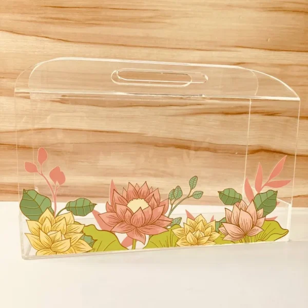 Transparent acrylic horizontal bag with multicolor lotus floral print, front view.