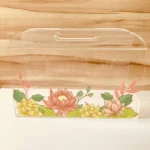 Decorative lotus print acrylic bag styled with festive flowers.