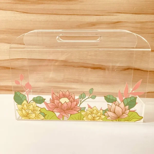 Acrylic floral horizontal bag placed on a wooden background.
