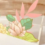 Close-up of lotus flower print on clear acrylic bag surface.