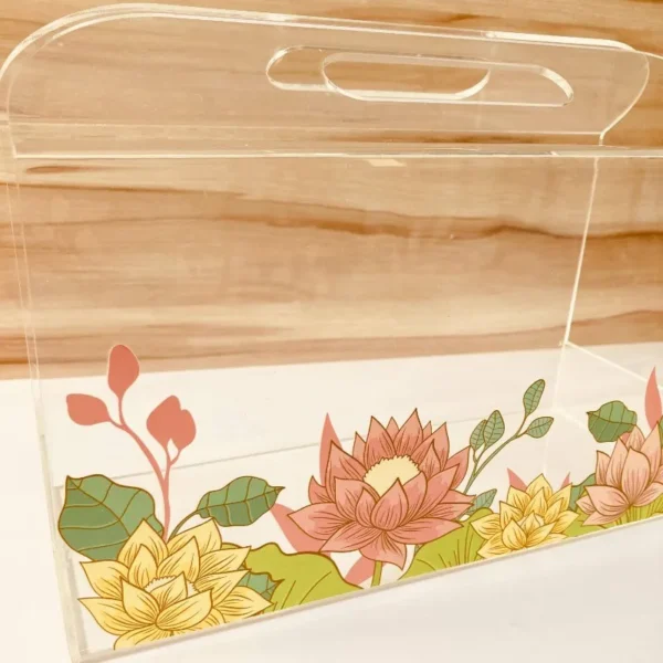 Side view of floral printed acrylic horizontal bag with handle.