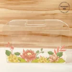 Transparent acrylic horizontal bag with multicolor lotus floral print, front view.