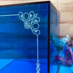Close-up of elegant printed border design on blue acrylic box.