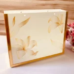 Side view of Golden Cross Bag showing metallic frame edges.