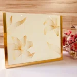 Golden Cross Bag in acrylic with golden floral prints, front view.