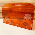 Horizontal acrylic bag with built-in handle, angled shot.