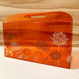 Orange acrylic horizontal bag with lotus prints, front view.