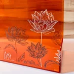Close-up of lotus flower detailing on acrylic bag surface.