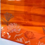 Close-up of lotus flower detailing on acrylic bag surface.