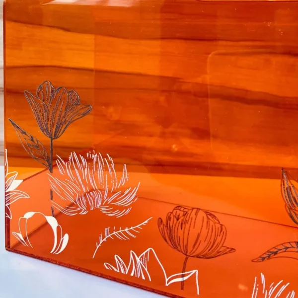 Close-up of lotus flower detailing on acrylic bag surface.