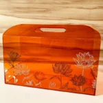 Acrylic lotus print horizontal bag styled with flowers.
