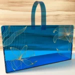 Premium acrylic blue basket with golden design, perspective shot.