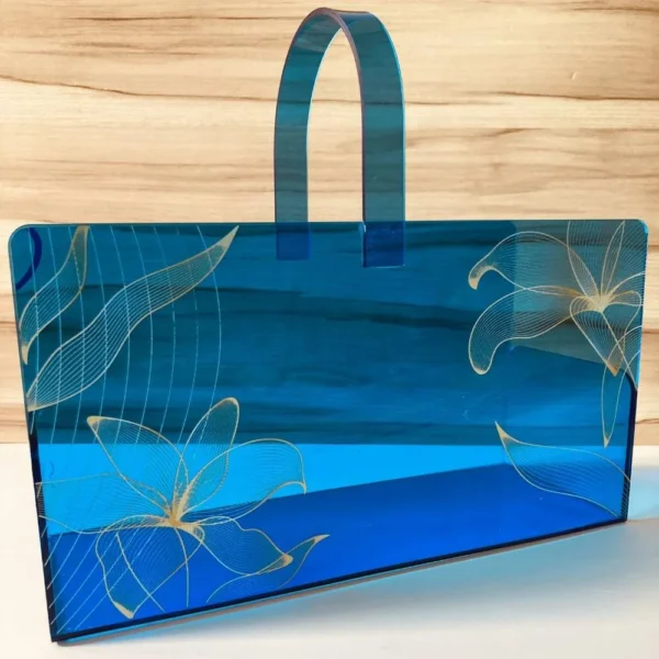 Premium acrylic blue basket with golden design, perspective shot.
