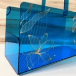 Angled view of long printed acrylic basket on wooden background.