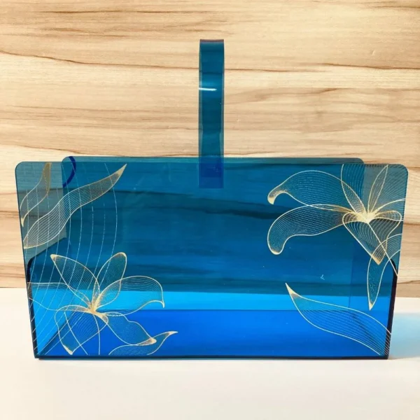 Blue acrylic long basket with golden floral print, front view.