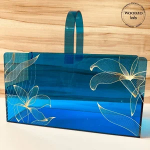 Blue acrylic long basket with golden floral print, front view.