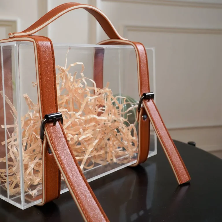 Close-up of buckle details on the leather strap of the suitcase box.