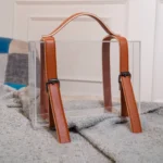 Acrylic box with brown leather handle used for luxury gift packing.