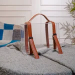 Elegant suitcase-style box used as table decor near indoor plants.