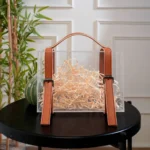 Gift-ready suitcase box placed against a panelled wall background.