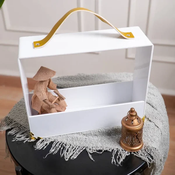 Side view of acrylic gift carrier showing white base and clear front panel.