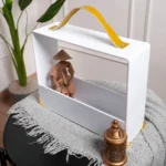 Luxury acrylic gift carrier styled with minimalistic decor items inside.