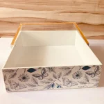 Side angle of butterfly design gold tray with handle.