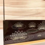 Black acrylic printed hamper basket with lotus motif.