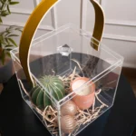 Close-up of mustard leather handle attached to acrylic gift box lid.