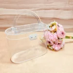 Clear oval acrylic basket hamper with handle.