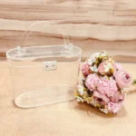 Oval transparent hamper basket placed on a wooden background.