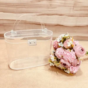 Oval transparent hamper basket placed on a wooden background.